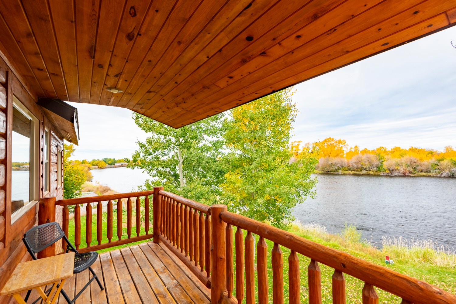Outdoor table, chairs, and hammock beside Henry's Fork